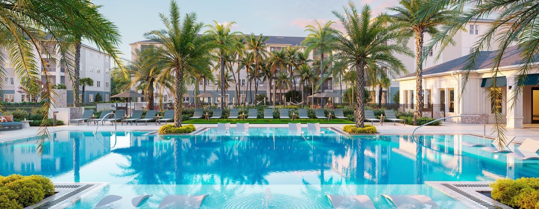 a pool with palm trees and a building in the background