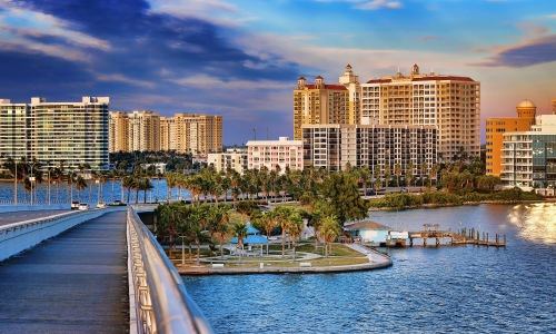 Sarasota florida skyline pedestrian bridge sunset water high rises palm trees
