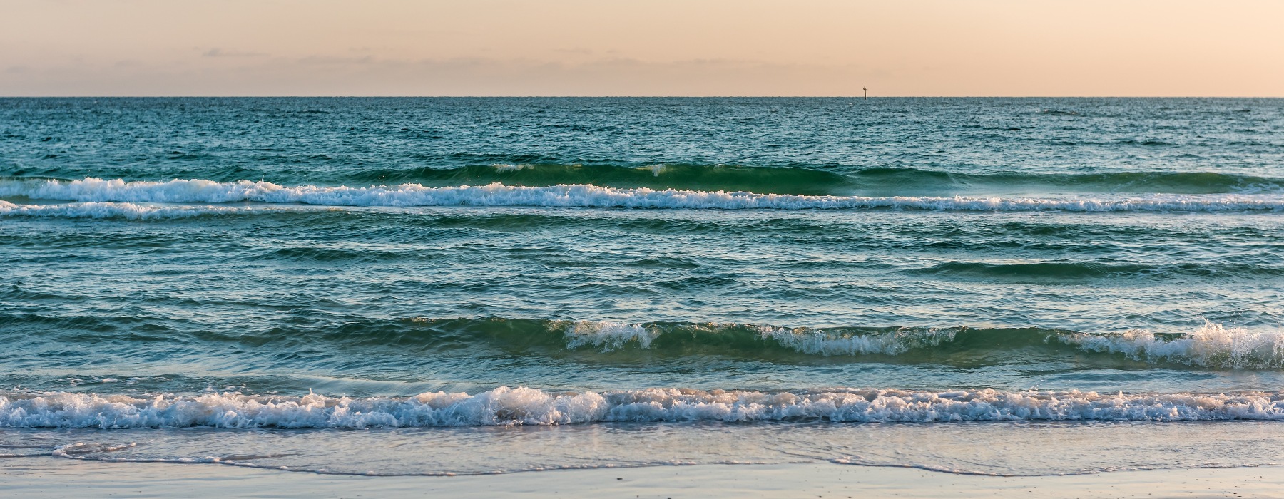 sunset beach shore waves blue water gold sky