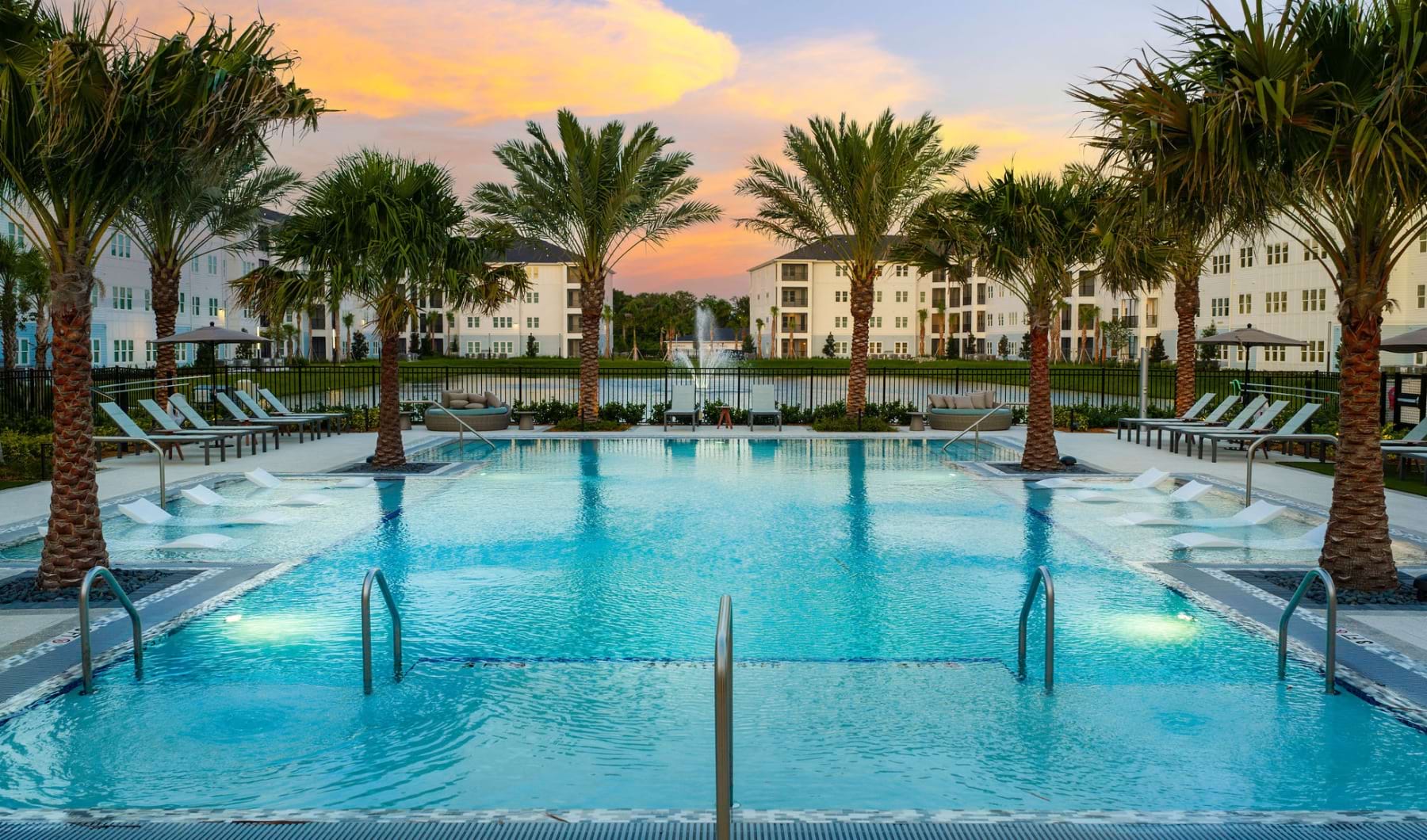 melina sarasota swimming pool evening sunset palm trees loungers water