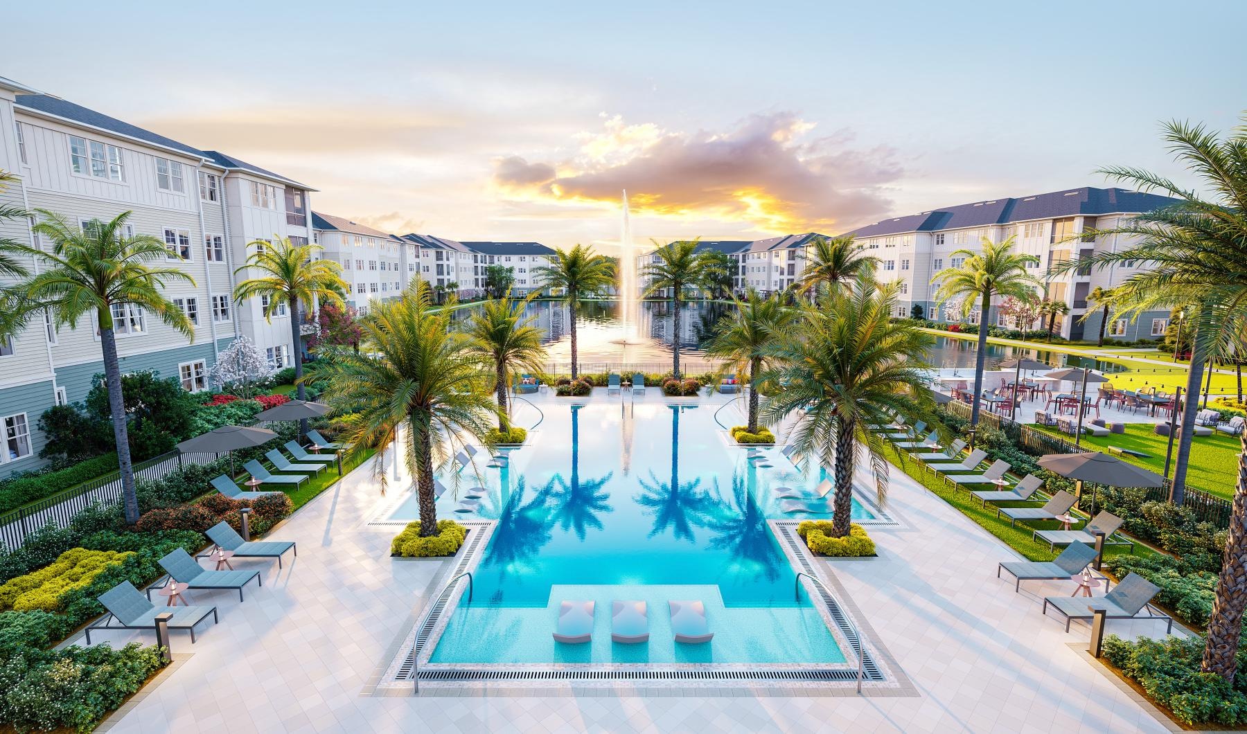 a pool surrounded by palm trees and buildings